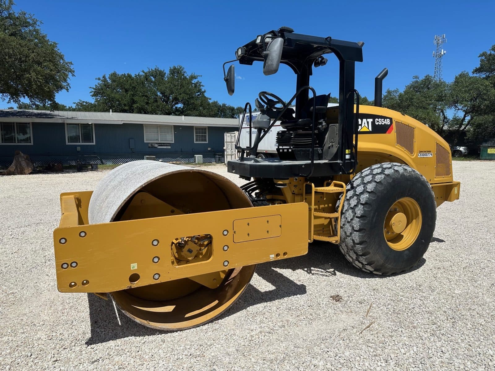 2019 Caterpillar CS54B vibratory soil compactor with 84-inch smooth drum, front-left view, for sale in Texas